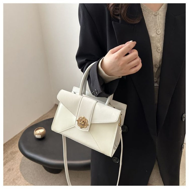 A Compact Shoulder Bag for Women Featuring a Square Lock Clasp And a Zipper System with an Additional Compartment, Ideal for Daily Commutes And Travel. This Multi-Colored Crossbody Bag Serves As a Versatile Everyday Handbag